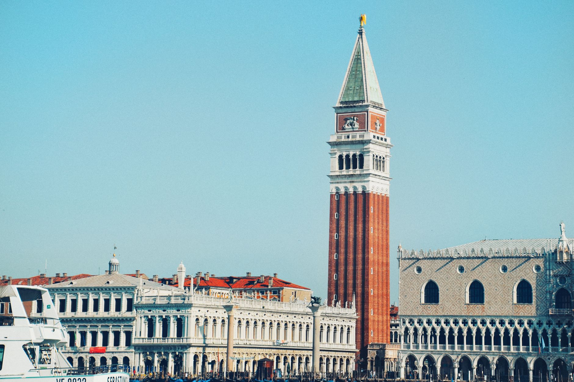 Iconic St Mark's Campanile and Doge's Palace viewed from the canal in Venice, Italy.